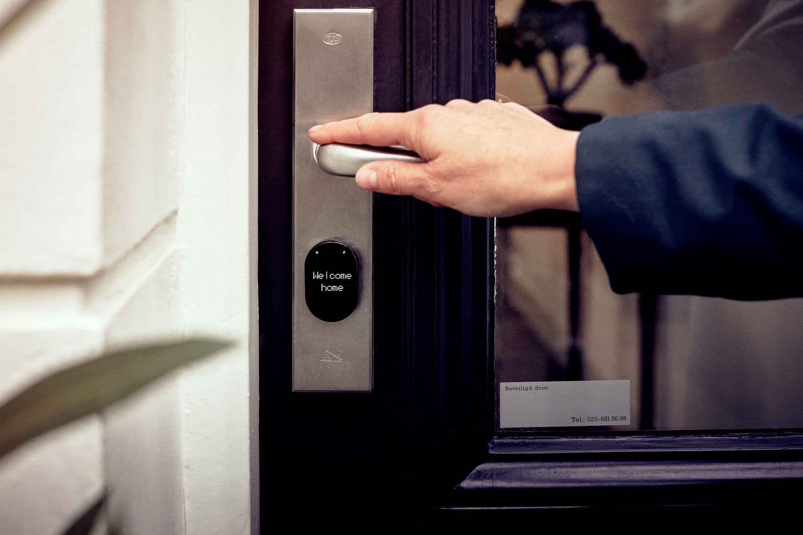 Smart lock on a door — close crop on hands